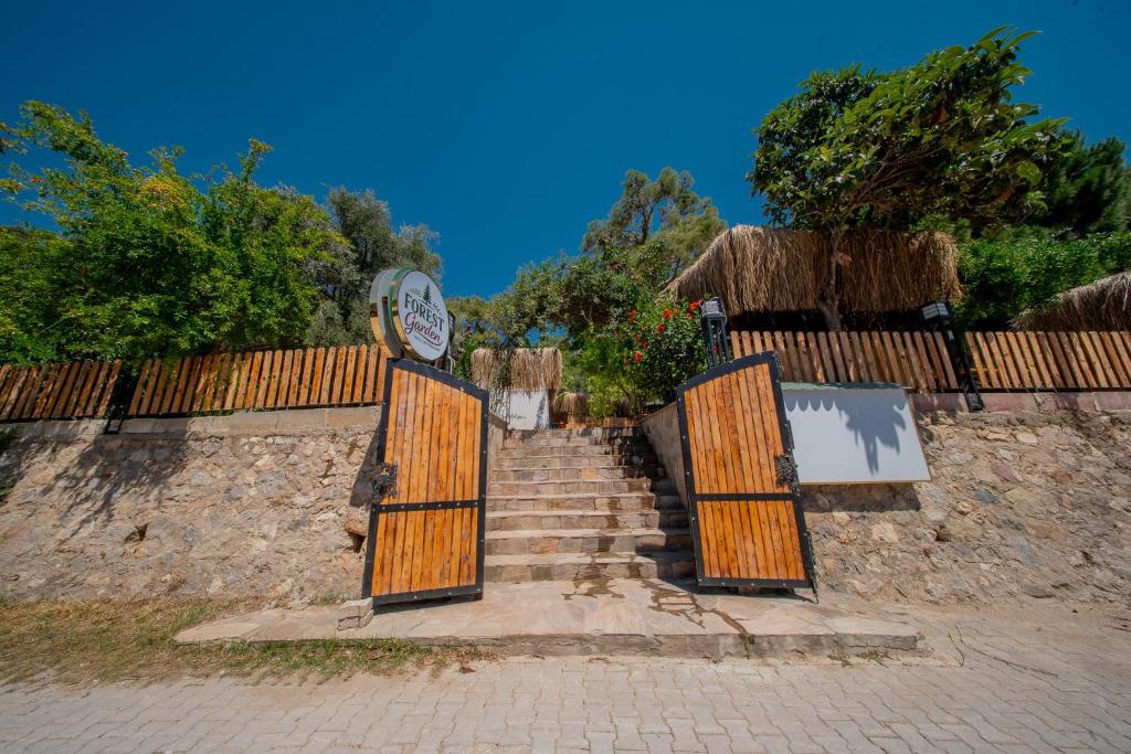 a set of stairs with wooden gates and a fence at Forest Garden in Goynuk