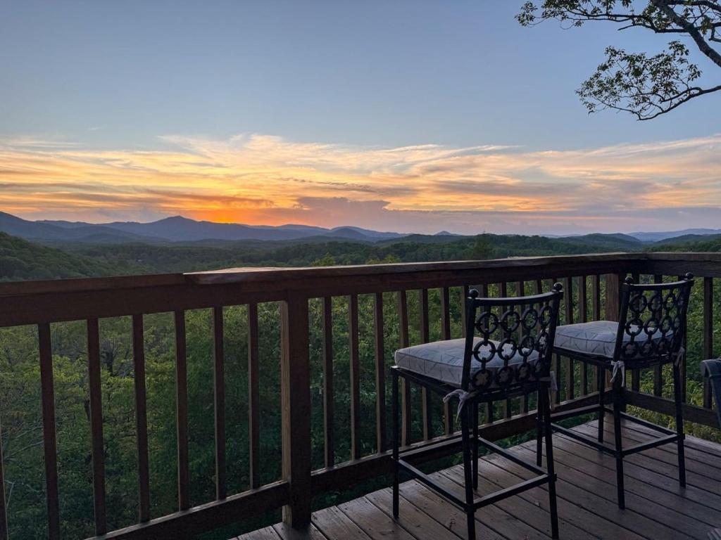 two chairs on a deck with a view of the mountains at Misty Ridge Retreat in Blowing Rock