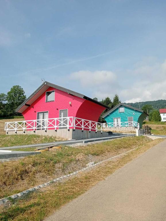 a red barn on the side of a road at Domki Ale Góry Beskid Żywiecki Korbielów in Korbielów