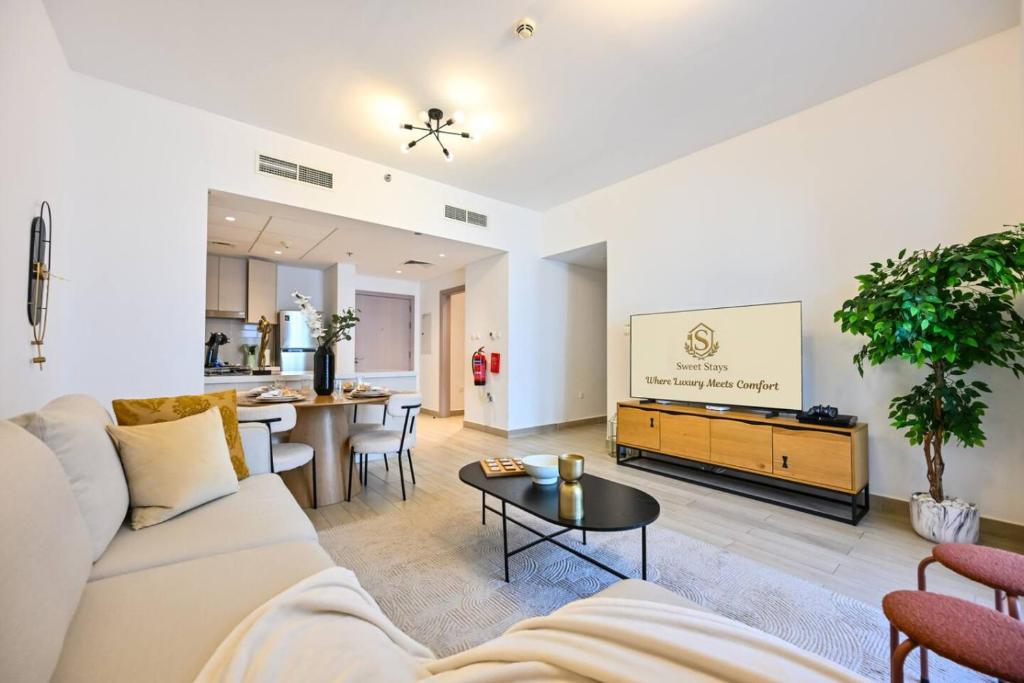 a living room with a couch and a table at Yas Island 2BR | Pool | Near Ferrari World & Mall in Abu Dhabi