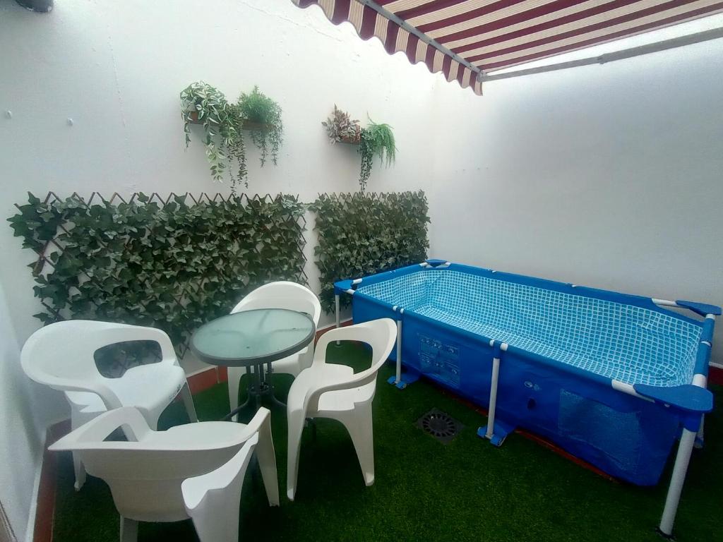 a patio with a table and chairs and a pool at Casa Villa Duque in El Bosque