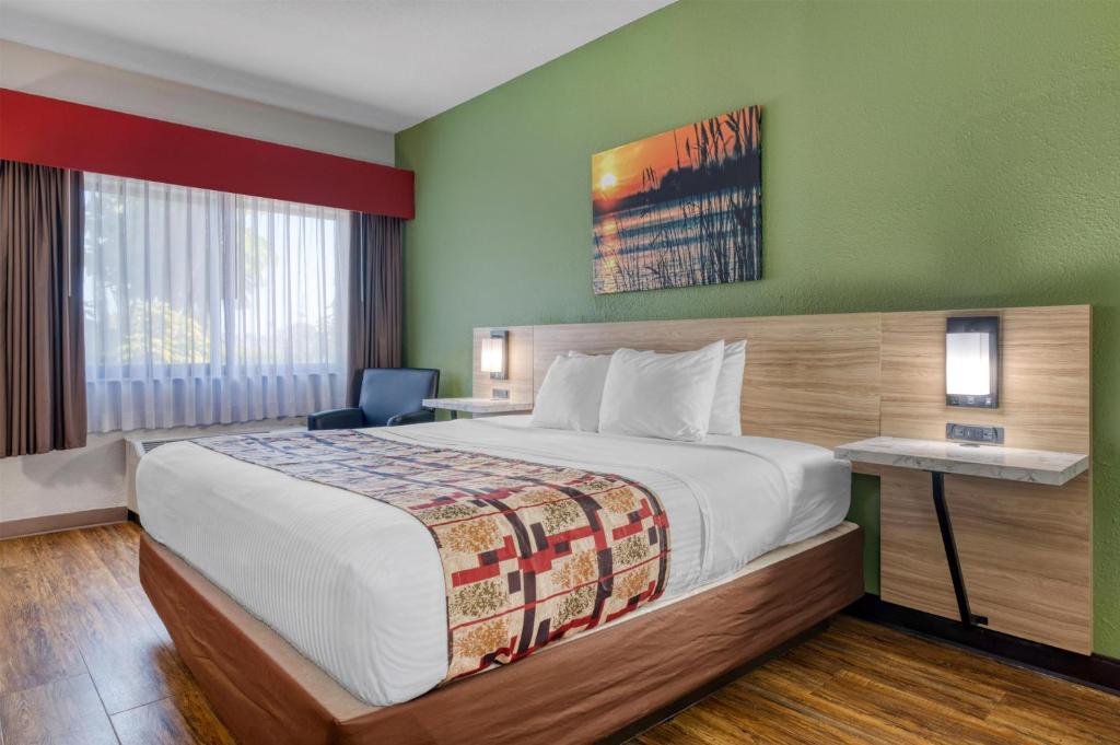 a hotel room with a large bed and a desk at Best Western Lake Okeechobee in Okeechobee