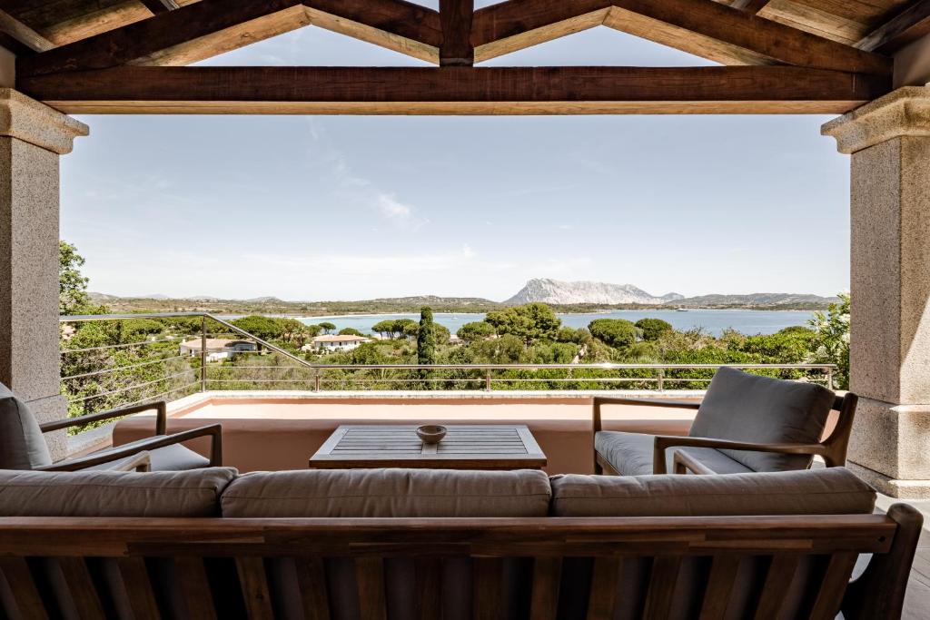 a living room with a couch and a large window at BeLocations - Aldia Garden Seaview in Puntaldia