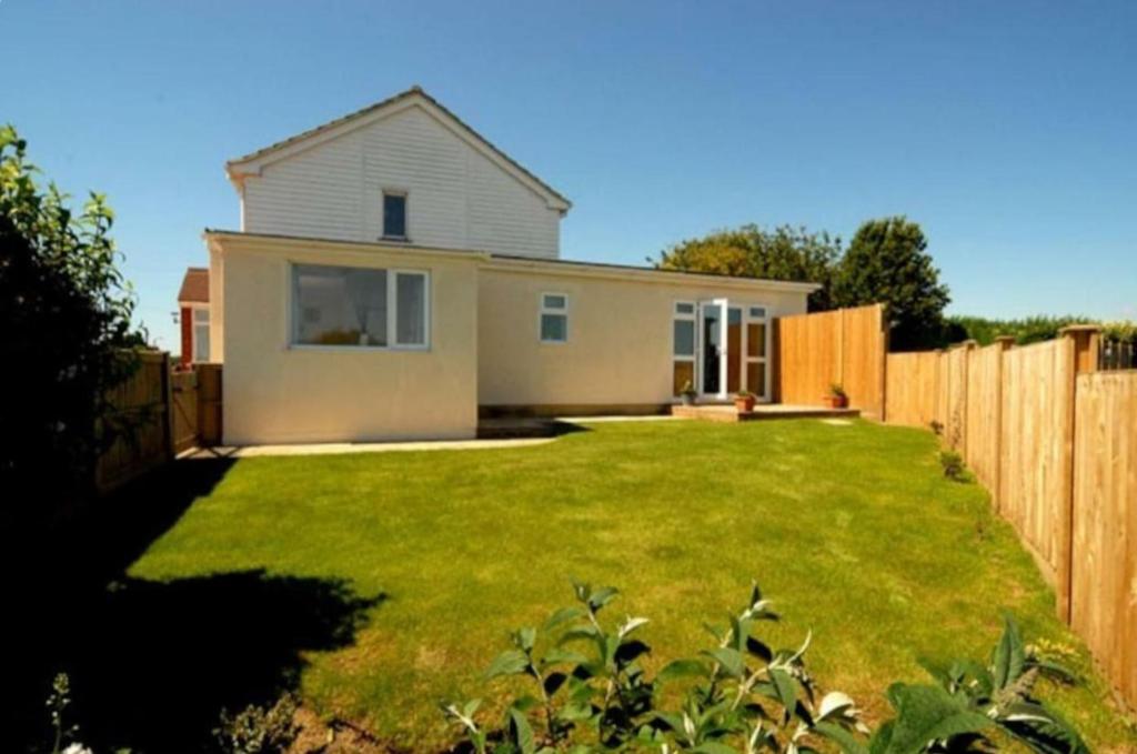 a house in a yard with a fence at Castle View Dover in Dover