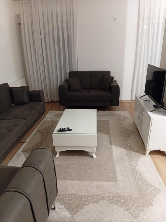 a living room with a couch and a coffee table at Pristhine Stay Inn 20 in Prishtinë