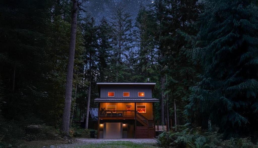 a small house in the woods at night at Timberline Terrace in Glacier