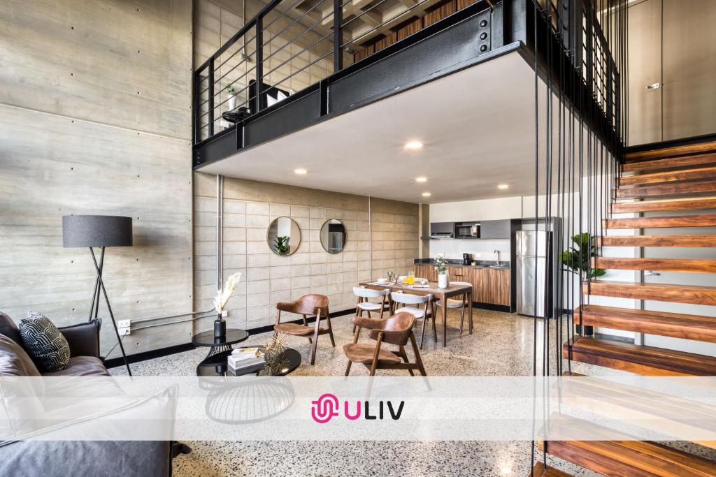 a living room with a table and a dining room at Downtown Loft by ULIV in Tijuana
