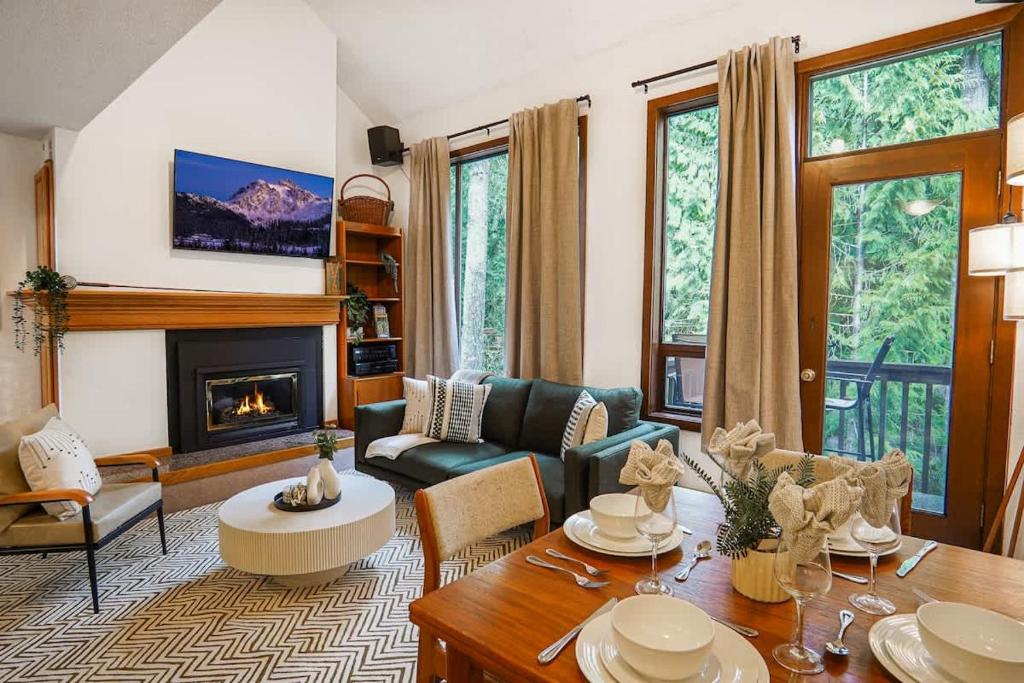 a living room with a couch and a fireplace at Cascade Peaks in Glacier