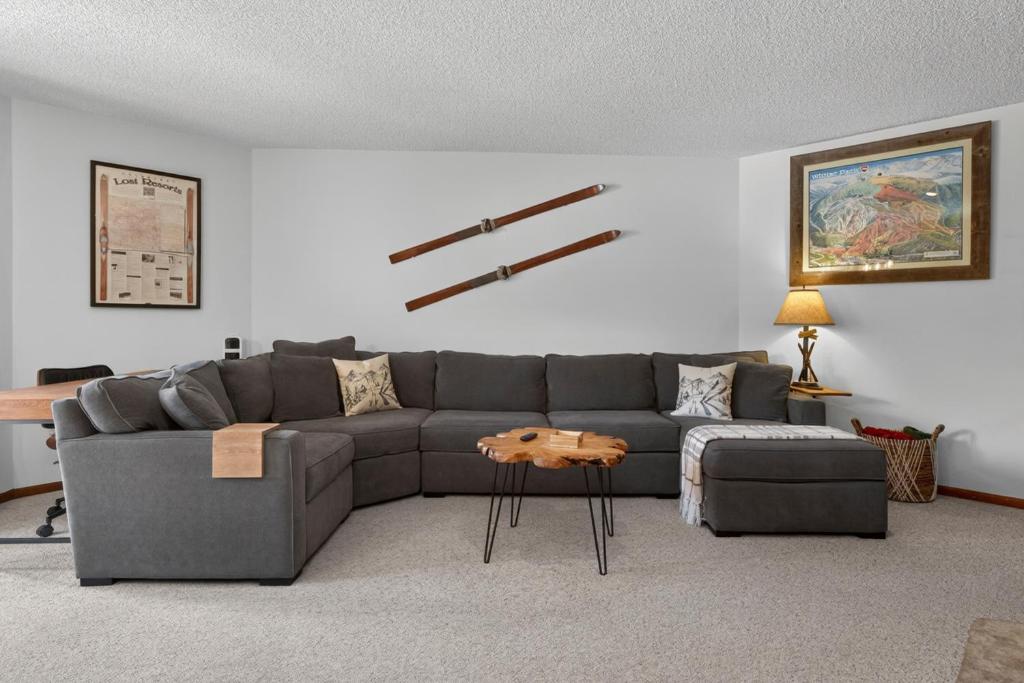 a living room with a gray couch and a table at Winter Park Place #18 in Winter Park