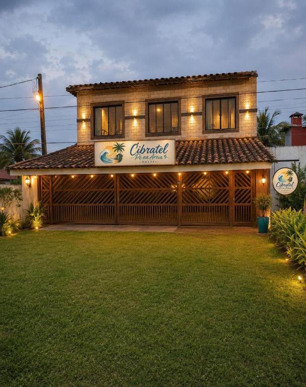 a house with a sign that reads emerald at Cibratel Hostel - Pé na Areia in Itanhaém