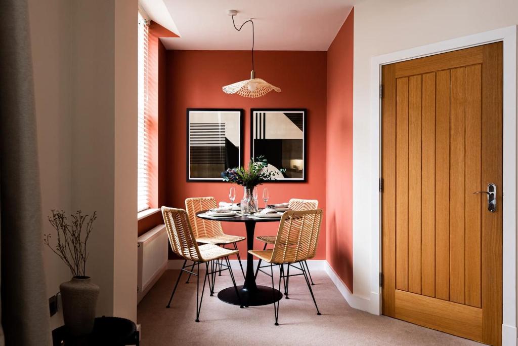 a dining room with a table and chairs at Town Centre - Elegant Stylish Apartment in Shrewsbury