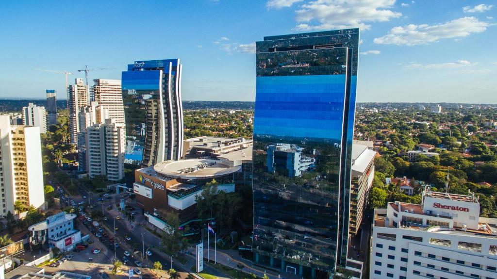 a view of a city with a tall building at Paseo La Galería Hotel & Suites in Asunción