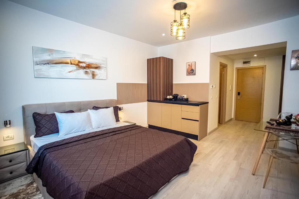 a bedroom with a bed and a desk in a room at Ariana Deluxe Suites in Bucharest