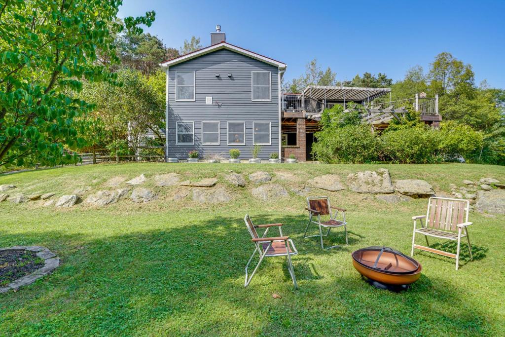 a yard with chairs and a house in the background at Hudson Valley Multi-Unit Escape: Secluded + Scenic in Claverack