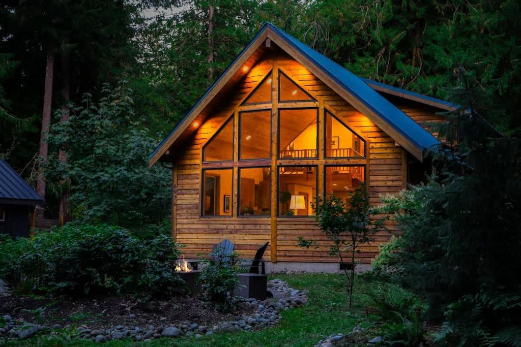 a log cabin with a large glass window at Church Mountain View Chalet in Glacier