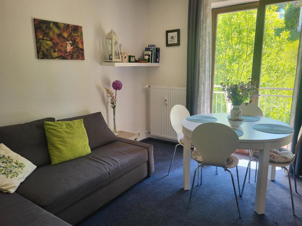 a living room with a couch and a table at Family Apartment, 2 Bedrooms, 2 Bathrooms, Bavarian Forest in Mitterfirmiansreut