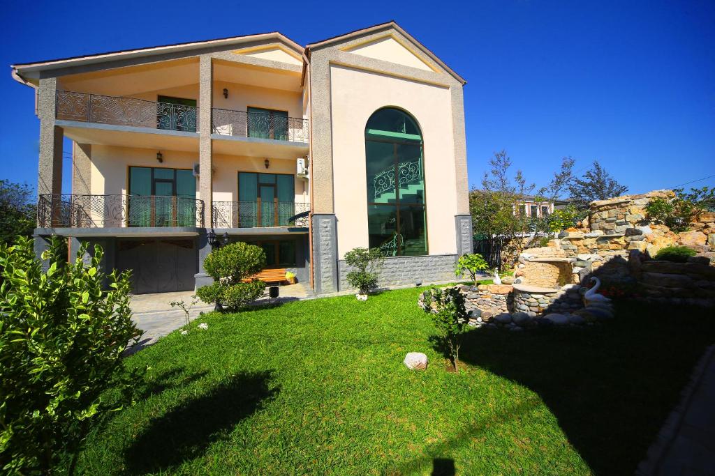 a large house with a yard in front of it at Hotel Harmony in Kutaisi