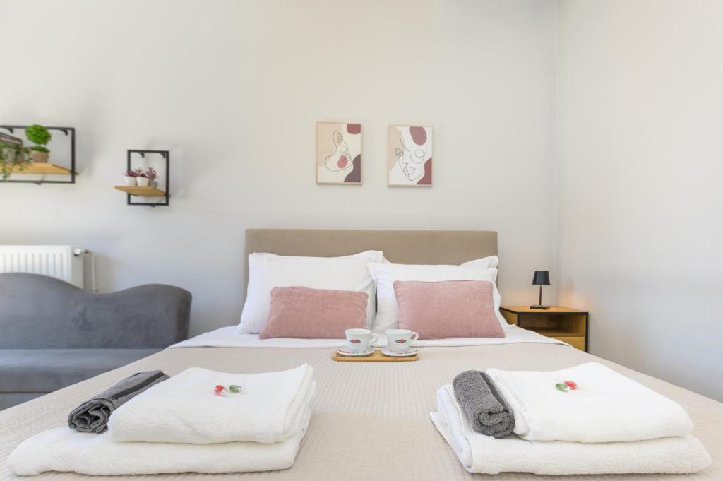 a bedroom with a bed with two towels on it at Rania's Seaside Nest- Steps from the Beach in Kiaton