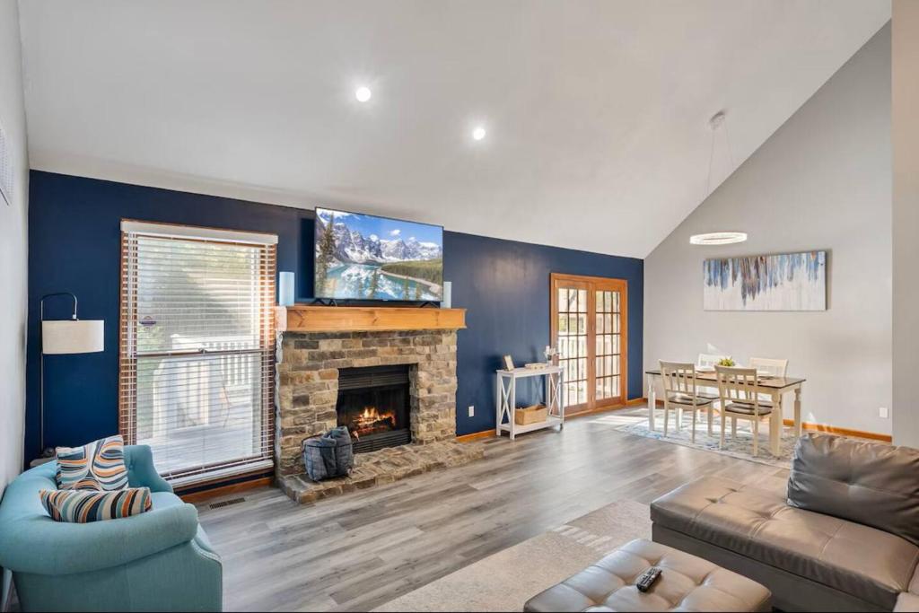 a living room with a couch and a fireplace at The Welcome Home in Topeka