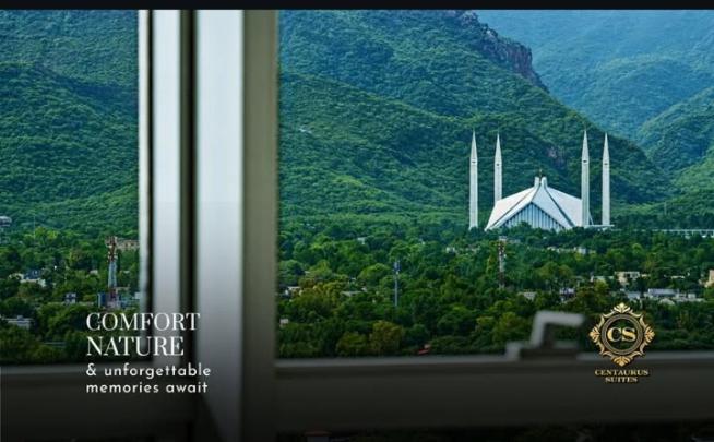 a window with a view of a white building at AH apartments in Rawalpindi