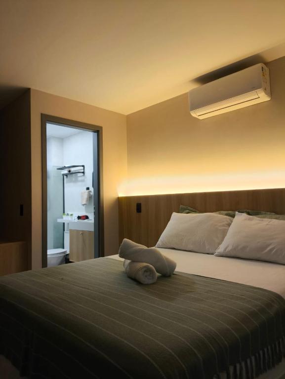 a bedroom with a bed with a pillow on it at Flat 4 Mares - Refugio a dois - Com piscina e estacionamento em Intermares in Cabedelo