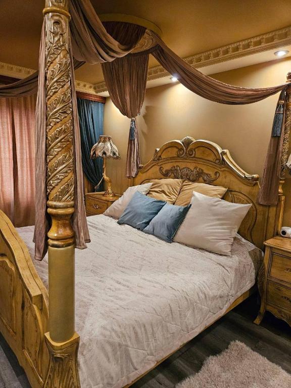 a bedroom with a bed with a canopy at Royal View Apartment in Liepāja