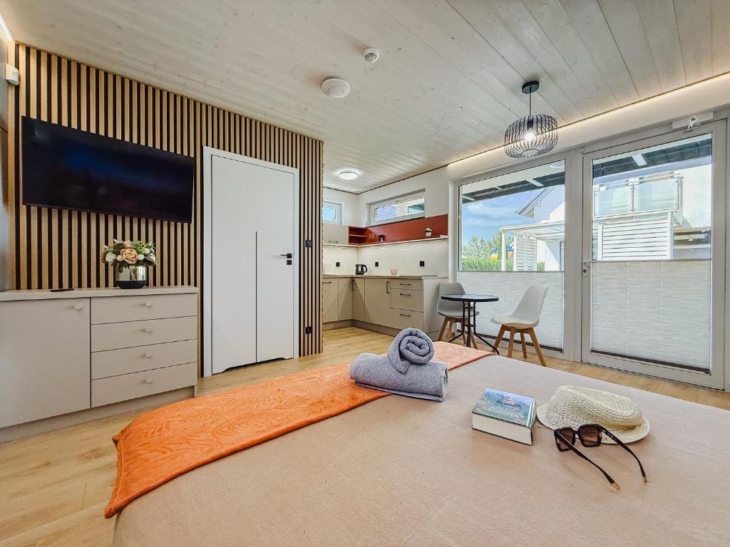 a bedroom with a bed with a towel on it at Morski Raj Apartamenty in Dębki