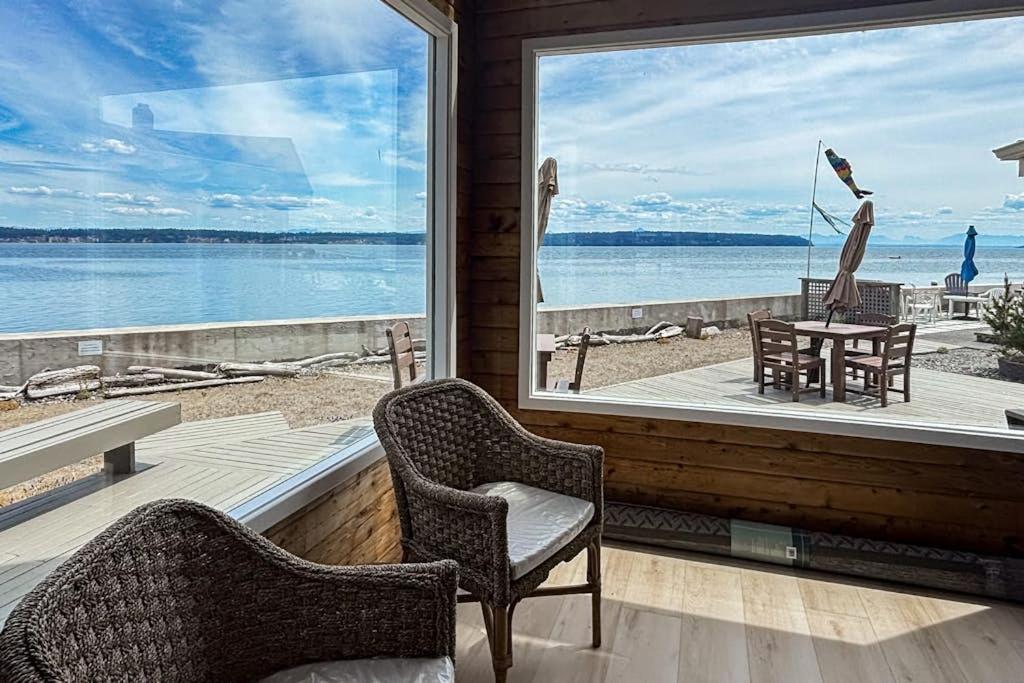 a room with two chairs and a large window at Sea Side Cedar in Langley