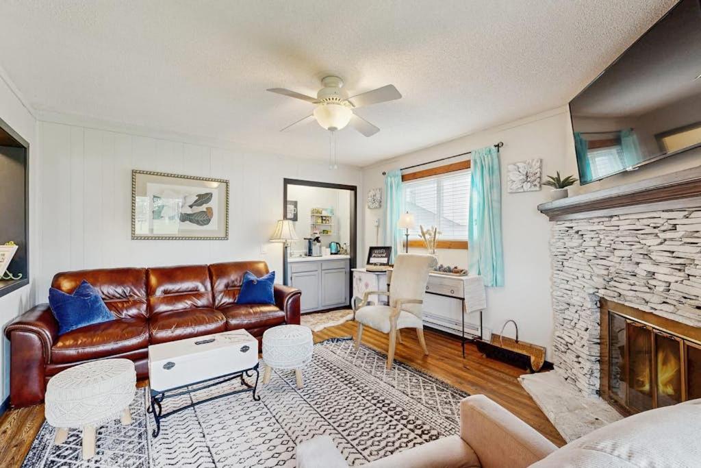 a living room with a leather couch and a fireplace at Pinnacle 2101 in Beech Mountain