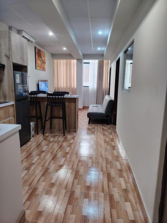 a kitchen and living room with a wooden floor at Departamento Grupo in Lima