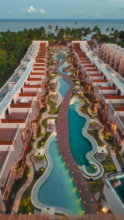 an aerial view of a resort with a river at NAAY - Nature 106 in Pôrto de Pedras