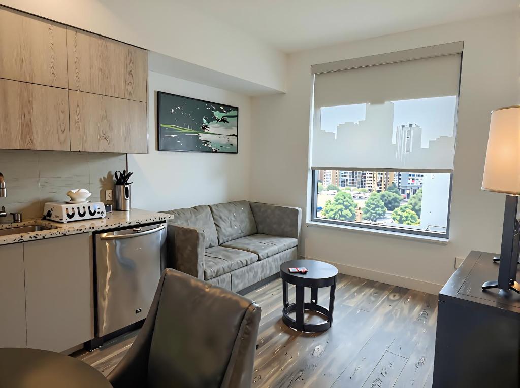 a kitchen and a living room with a couch at Premier Downtown Koreatown Apartment in Los Angeles