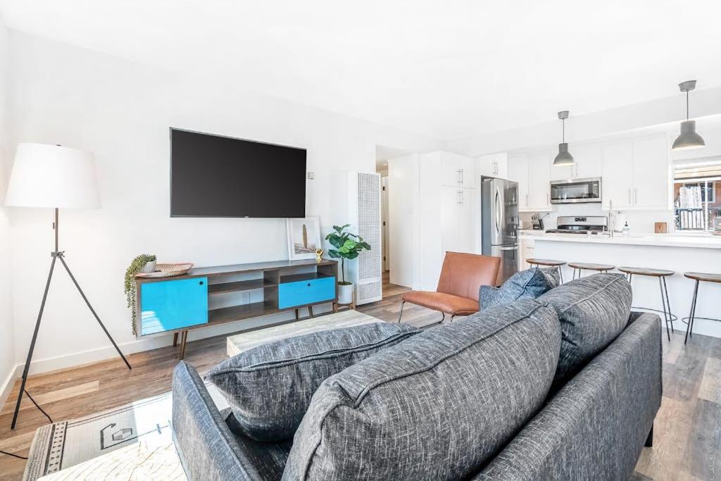a living room with a couch and a tv at Aloha-Howdy Surf Gateway in San Clemente