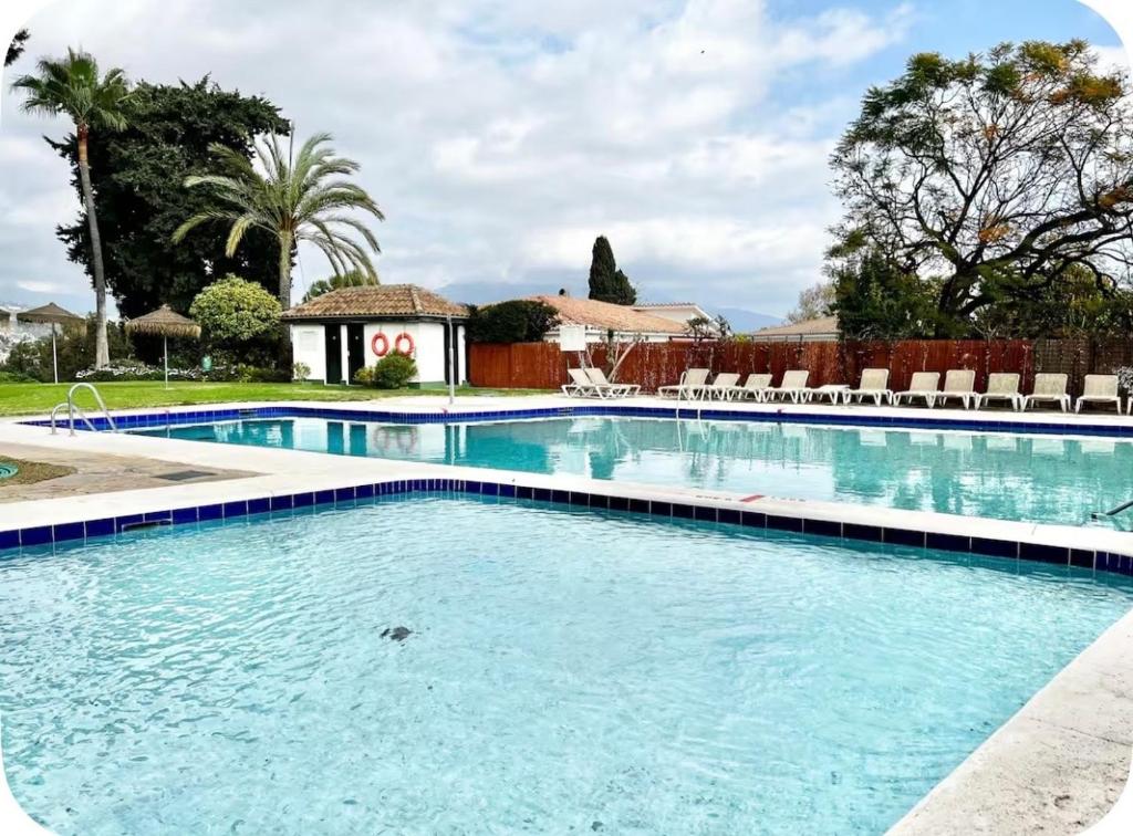 a swimming pool with blue water in a resort at Atalaya Green Nest in Estepona