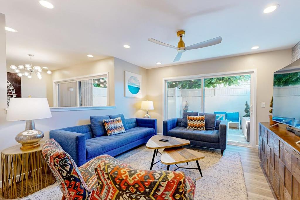 a living room with blue couches and a tv at Castles Reach in Anaheim