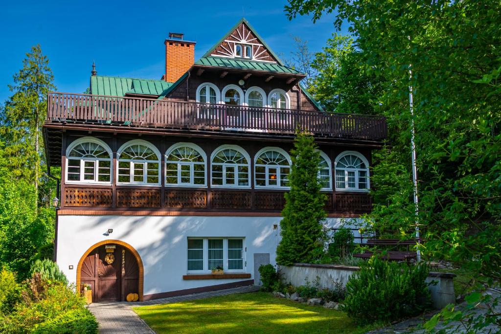 a house with a balcony on top of it at Willa JODŁA Wisła in Wisła
