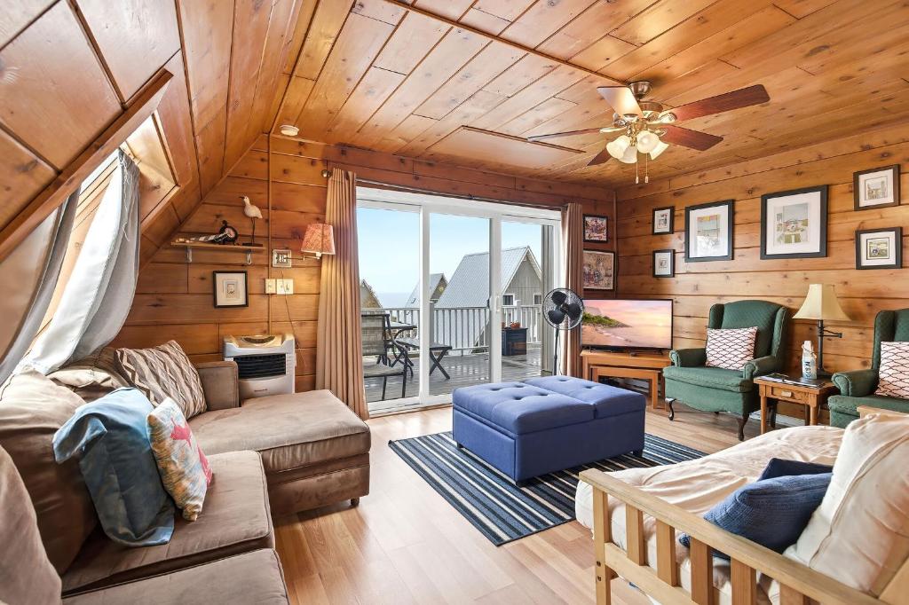 a living room with wooden walls and a ceiling at Chalet #29 in Stevensville