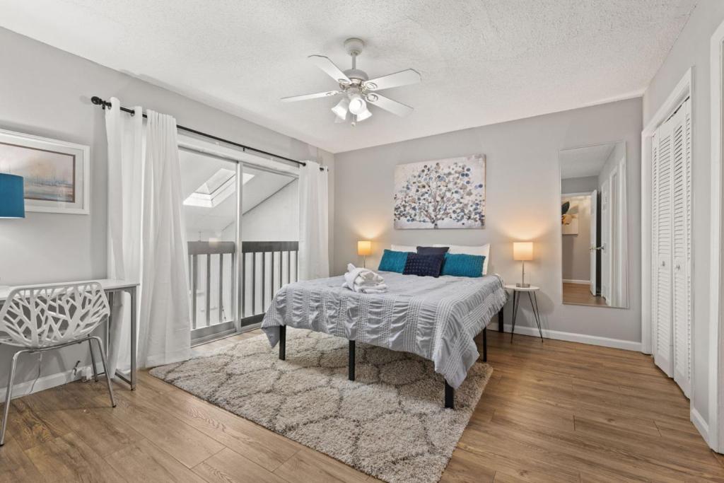a bedroom with a bed and a ceiling fan at Stay at Cypress Cottage in Charleston