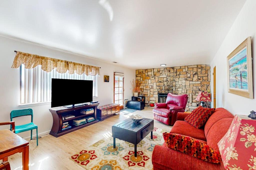 a living room with a red couch and a tv at See Star Ranch in Nipomo