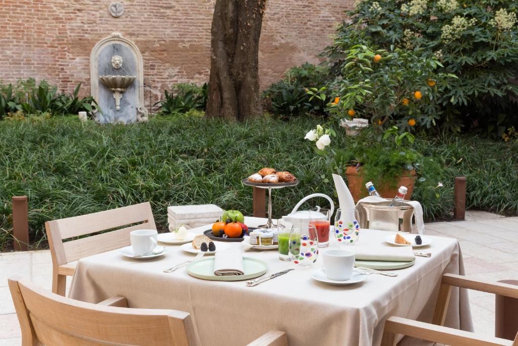 a table with a white table cloth with fruit on it at Palazzo Venart Luxury Hotel in Venice