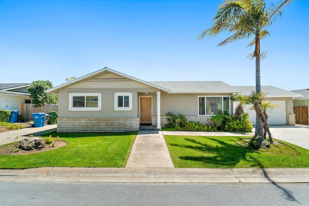 a house with a palm tree in the front yard at Morro Beach Bungalow in Morro Bay