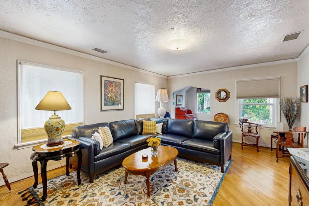 a living room with a black leather couch at Urban Ventura Oasis in Ventura