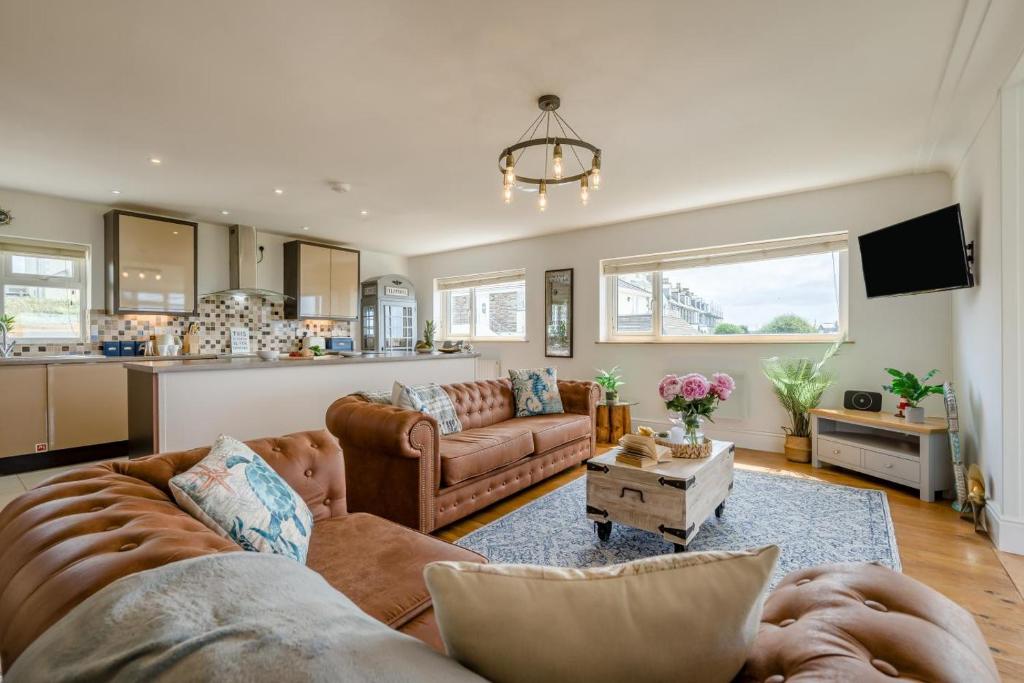 a living room with two couches and a kitchen at 3 Bed in Tintagel oc-a36172 in Tintagel