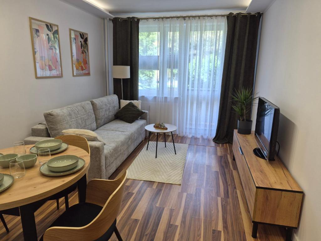 a living room with a couch and a table at Apartament przy Dworcu Sanok in Sanok