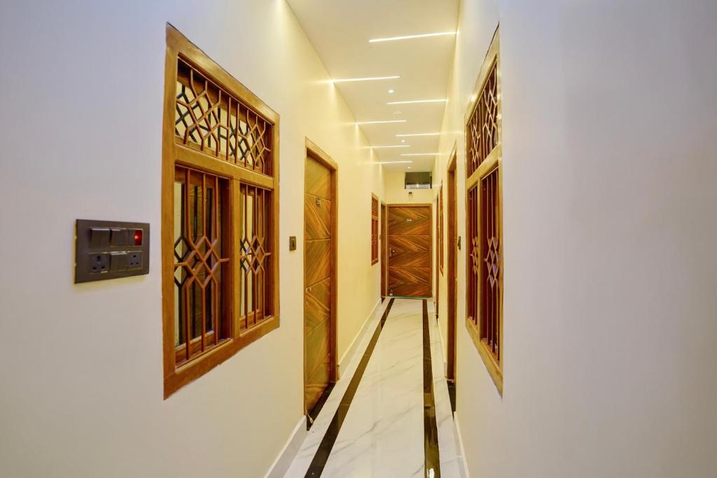 a corridor with wooden doors in a house at Hotel O SINGH GRAND HOTEL& BANQUET in Gorakhpur