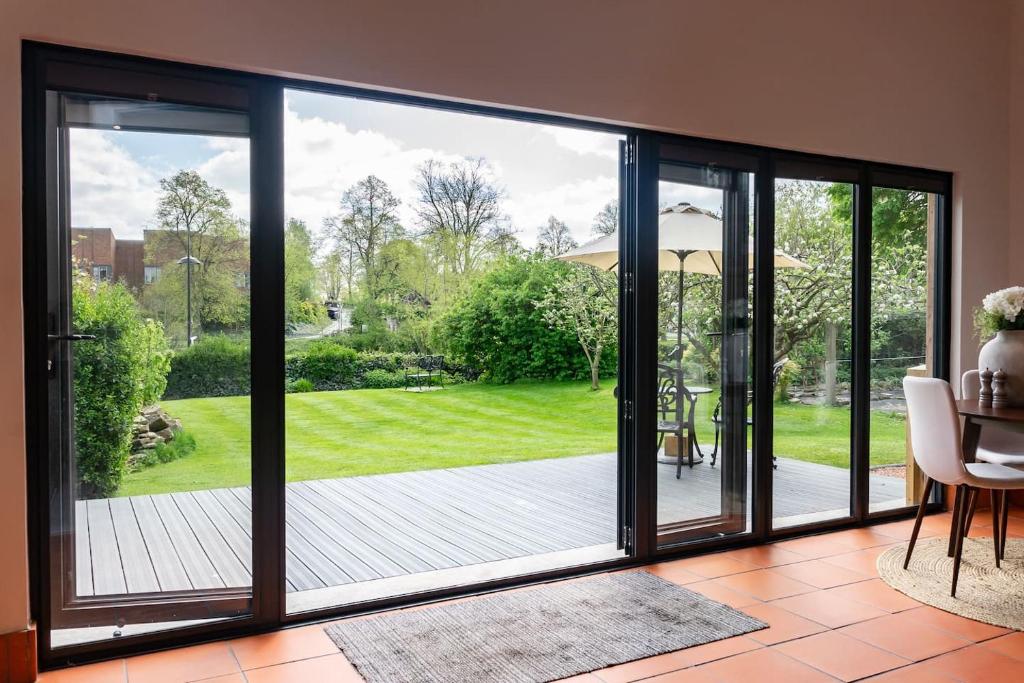 a sliding glass door with a view of a yard at Quarry View Studio in Shrewsbury with Parking in Shrewsbury