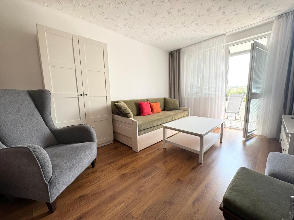 a living room with a couch and a table at Sinteu 3 bedroom apartment - 6PAX in Şinteu