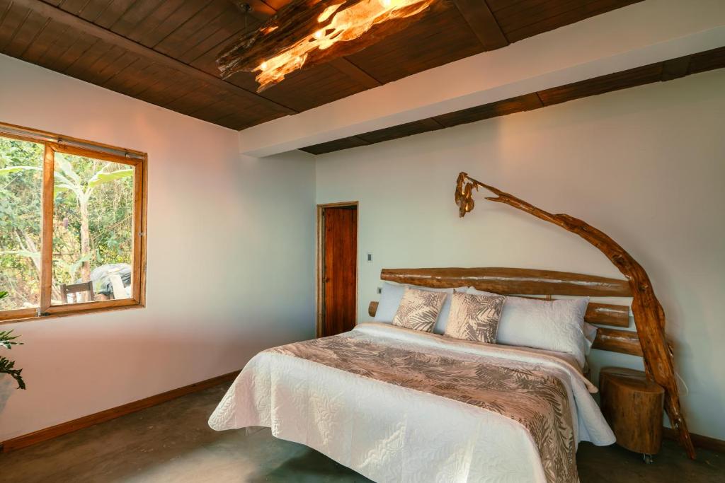 a bedroom with a bed and a window at Las Trincheras del Café in Chaparral