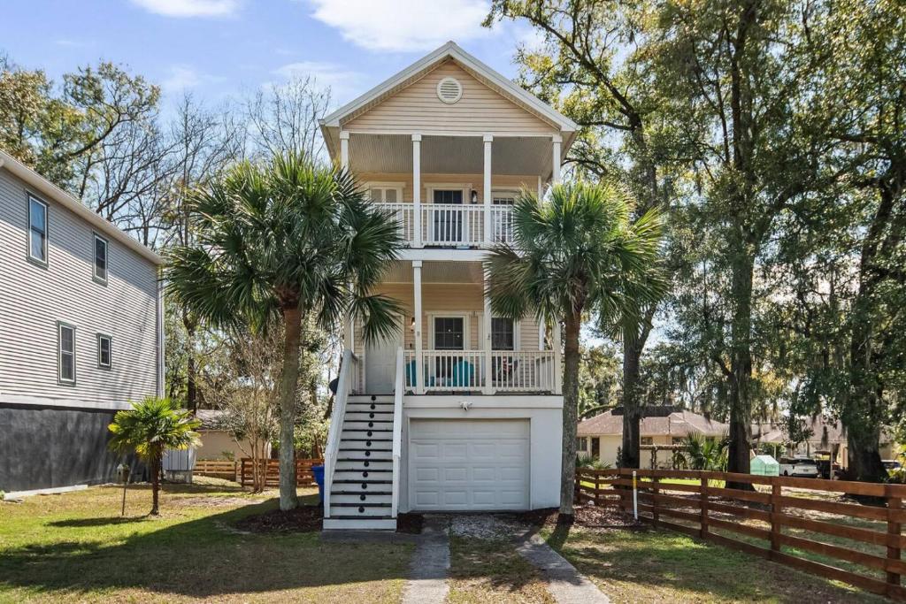 a house with a garage and two palm trees at Charleston 3BR Home · 3 Baths · Porches · Dogs OK in Charleston
