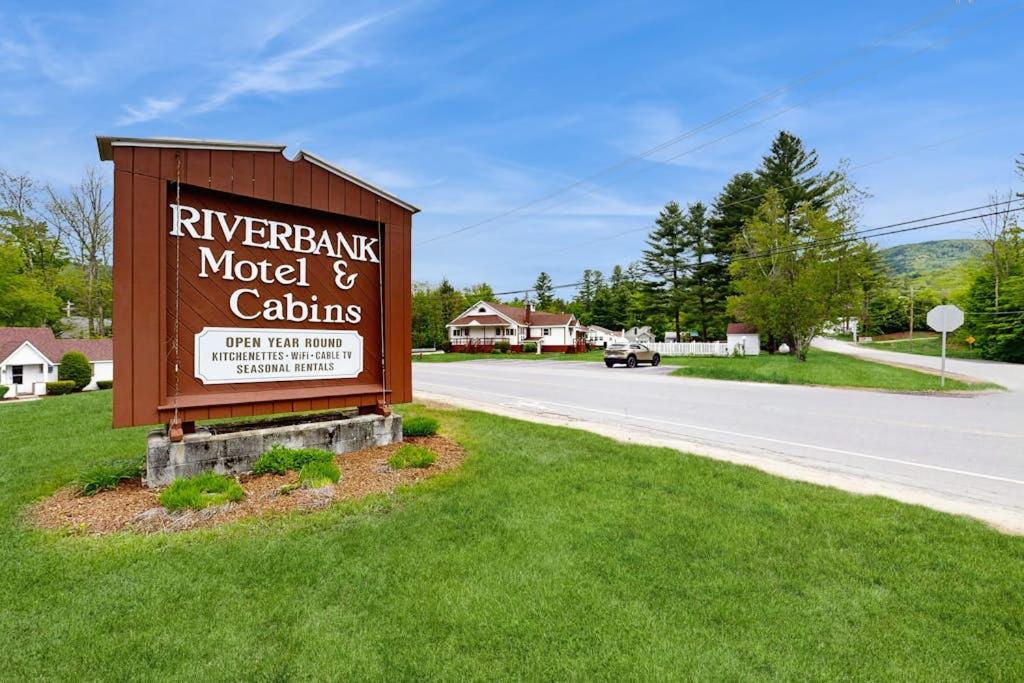 a sign for the riverbank motel and cottages on a road at Charming and casual motel in a great location with shared resort amenities in Lincoln